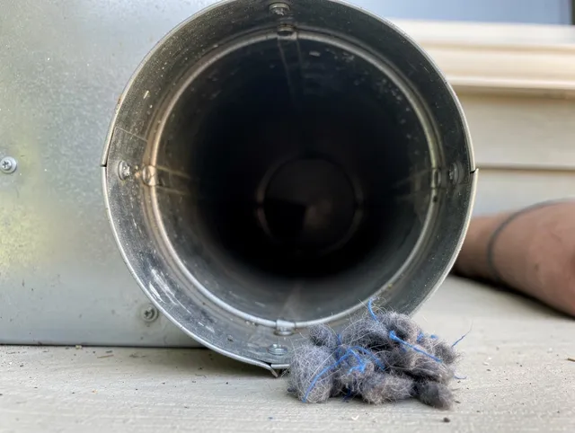 Bloomfield Dryer Vent Cleaning technician using specialized equipment to clear severe dryer vent blockage in Bloomfield